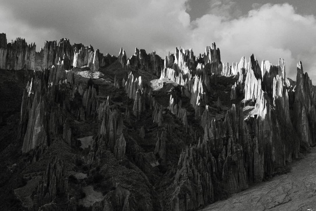 pointed rock ridges against the sky, in black and white